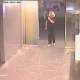 A homeless woman is caught peeing on the floor of an office building lobby by an employee. The whole event is captured on video by a security camera. No audio.